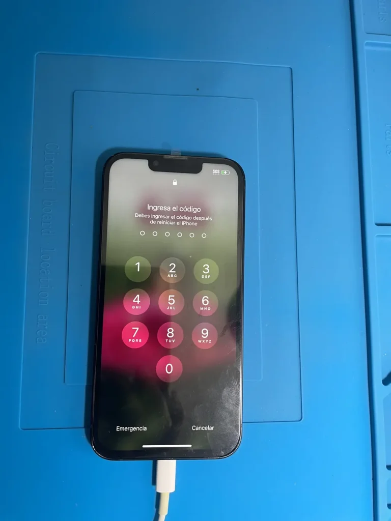 iPhone connected to a charging cable being tested after a charging port repair