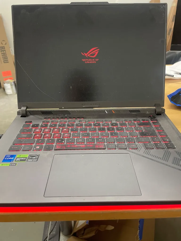 Gaming laptop on the bench being tested after a repair