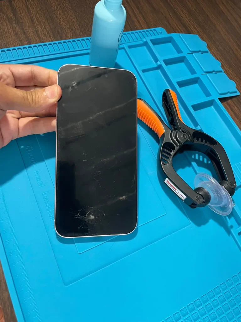 Phone in a clamp during a repair at YAS TECH