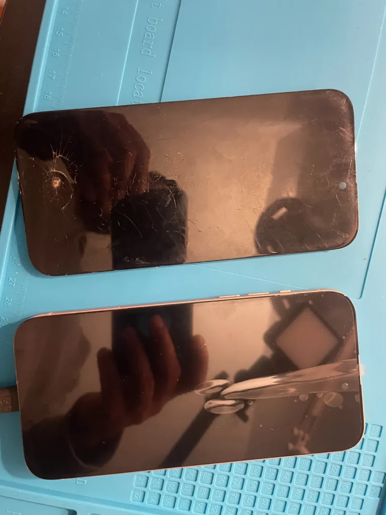 Two phone screens on the repair bench